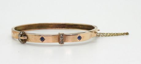 A 9ct rose gold sapphire and diamond buckle design bangle, Birmingham hallmarks for 1899, maker