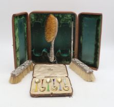 A cased late Victorian four piece dressing table set, Birmingham 1898, with scrolling foliate