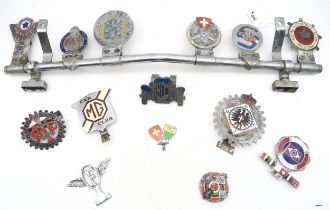 A collection of enamel automotive grille badges, to include the Automobile Club de L'ile de
