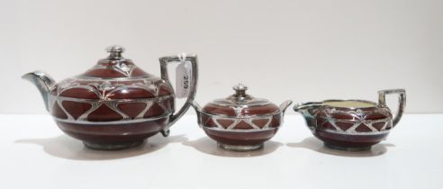 A brown glazed Wedgwood teaset with silver overlay decoration Condition Report:Available upon