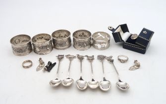 A collection of silver including a set of four stamped 'Sterling Silver' napkin rings, another