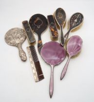 A collection of silver tortoiseshell dressing table items, including a hand mirror by Synyer &