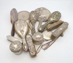A collection of silver dressing table items including a silver clothes brush, by William Comyns,