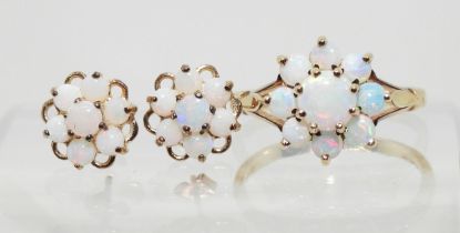 A 9ct gold opal flower ring with matching earrings. Finger size J, weight with the earrings 2.8gms