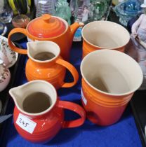 A Le Creuset orange teapot, two jugs (one red) and two utensil pots Condition Report:No condition