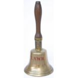 London & South Western Railway brass hand bell, engraved LSWR on the front and mounted on a mahogany