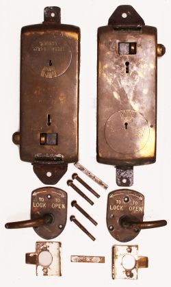 A pair of brass Toilet Door Locks complete with separate handles and strike plates but no keys.