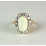An 18ct gold Victorian style opal and diamond oval cluster ring