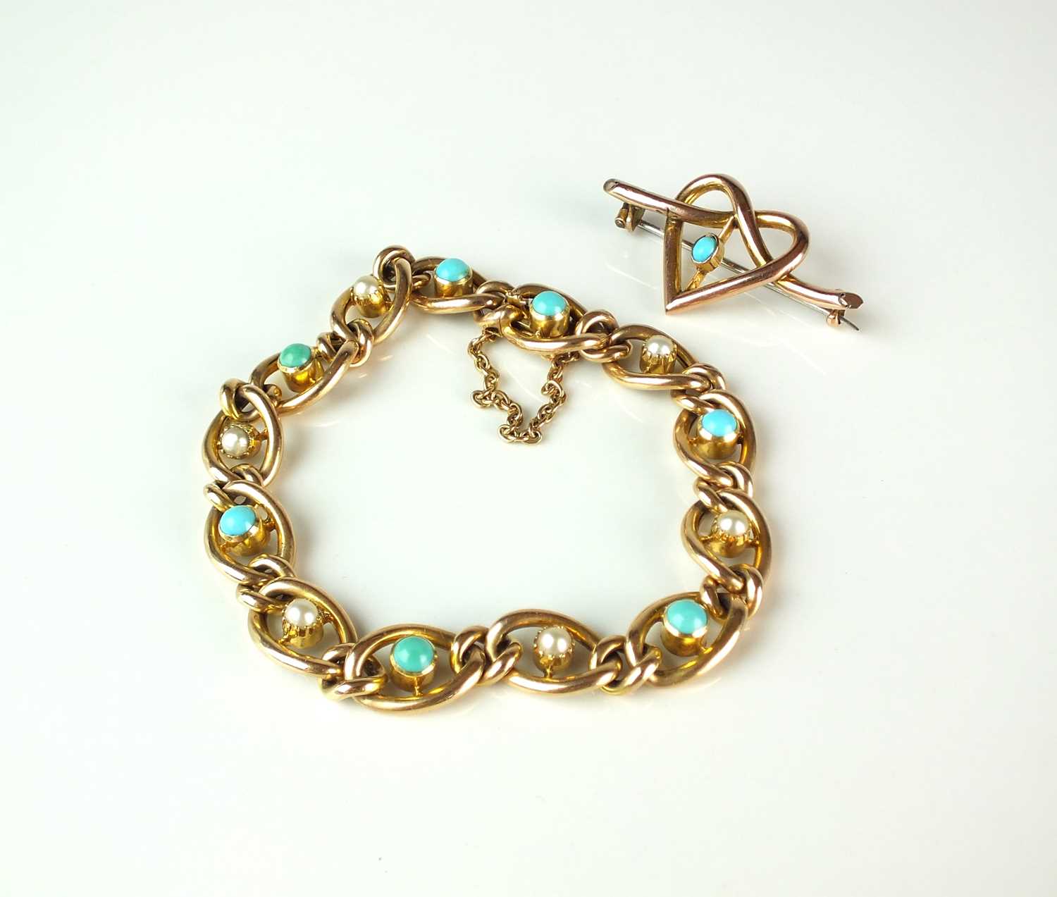 An early 20th century turquoise and seed pearl bracelet and a bar brooch