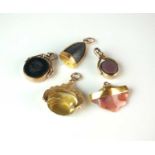 A collection of five gold and yellow metal mounted stone set fobs/charms