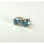 A pair of treated fancy blue diamond stud earrings