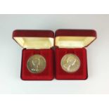 Two pairs of sterling silver medallions within fitted cases
