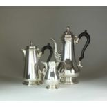 A silver coffee pot, hot water jug and cream jug