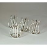 A set of four silver menu holders