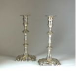 A pair of George II cast silver candlesticks