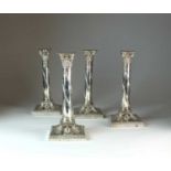 A set of four Victorian silver mounted candlesticks