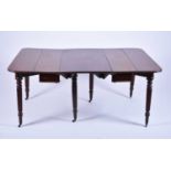 A Regency mahogany extending dining table with scissor-action