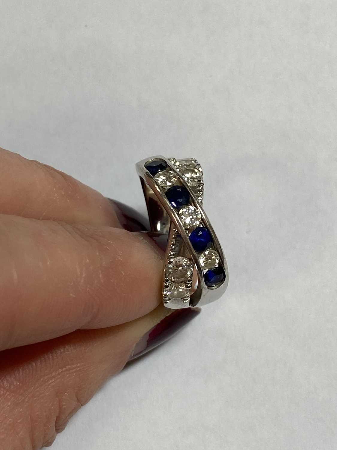 A diamond and sapphire crossover ring - Image 7 of 10