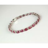 An 18ct white gold ruby and diamond line bracelet