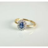 An 18ct gold sapphire and diamond oval cluster ring