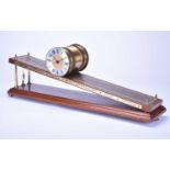 An inclined plane mahogany and brass, gravity, timepiece