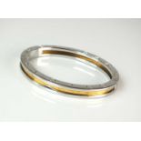 A yellow metal and stainless steel Bvlgari hinged bangle