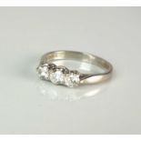 An 18ct white gold three stone diamond ring