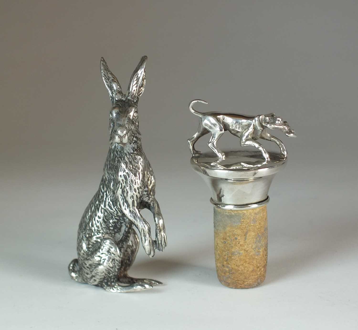 An Elizabeth II silver model of a hare and a white metal topped cork