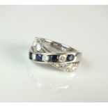 A diamond and sapphire crossover ring
