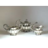 A matched three piece silver tea service