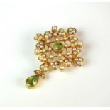 An early 20th century peridot and seed pearl set brooch/pendant