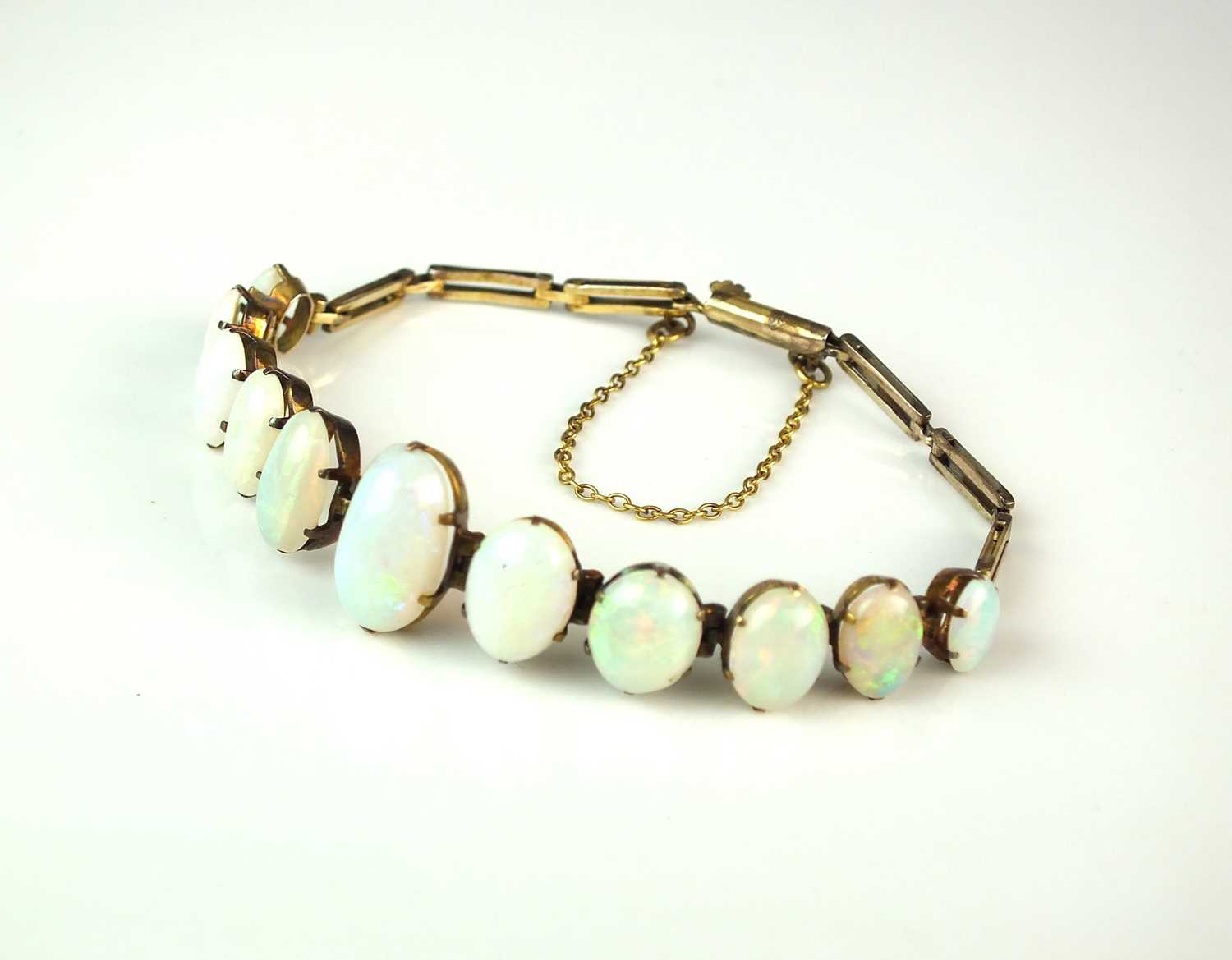 A yellow metal graduated opal bracelet