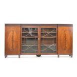 A 19th century inverted breakfront mahogany glazed bookcase cabinet