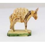 A Continental creamware model of a donkey, 19th century