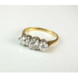 An 18ct gold three stone diamond ring