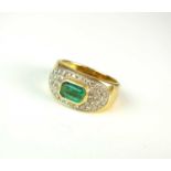 An emerald and diamond ring