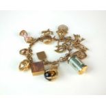 A 9ct gold bracelet with attached charms