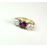 An 18ct gold three stone ruby and diamond ring