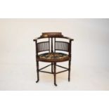 An Edwardian inlaid elbow or smokers chair