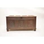 A carved and dated 18th century oak coffer