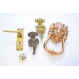An assembled group of reproduction brass door furniture and other hardware