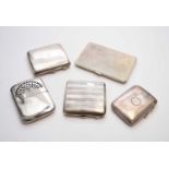 A collection of four silver cigarette cases and a plated hand warmer