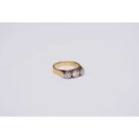 An 18ct gold three stone graduated diamond ring