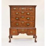 A George II feather-banded walnut chest on later stand