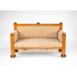 A Biedermeier parcel ebonised maple sofa