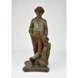 A recent cast and painted terracotta garden/conservatory figure of a golfer