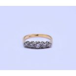 A yellow metal graduated five stone diamond ring