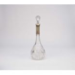 A white metal mounted cut glass decanter