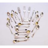 A collection of various pieces of silver and white metal flatware