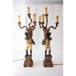 A pair of reproduction painted wood blackamoor table lamps